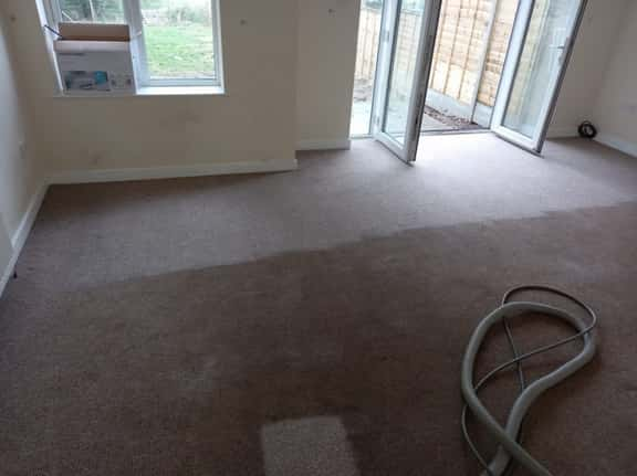 This is a photo of an empty living room with a brown carpet that is in the process of having its carpets steam cleaned works carried out by St Paul's Cray Carpet Cleaning